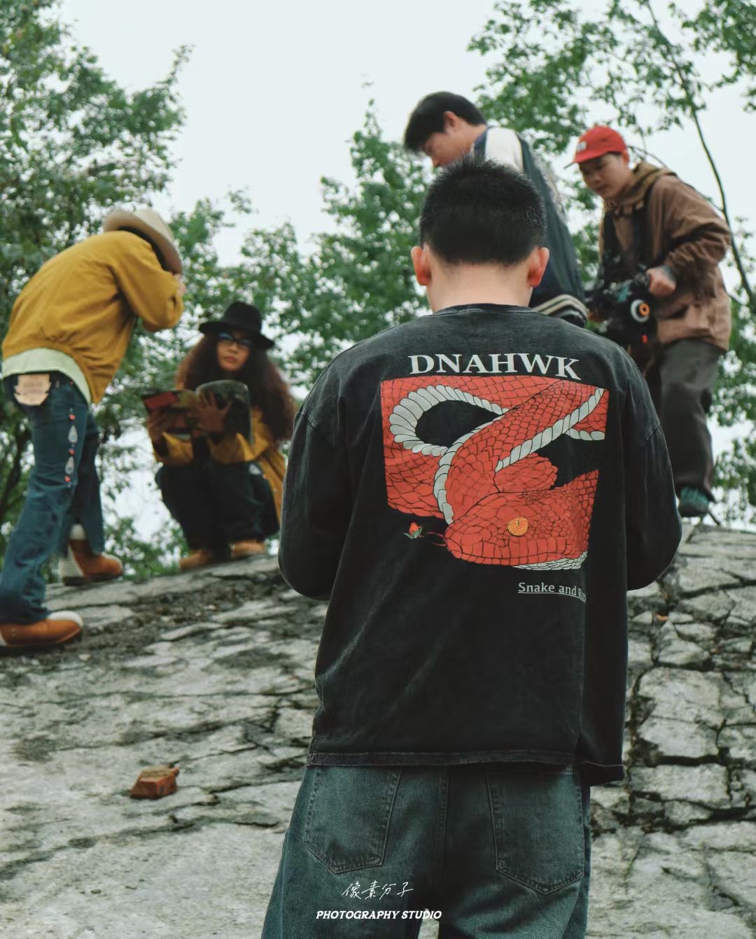 Behind the scenes on a location shoot, the crew at work on the rocks